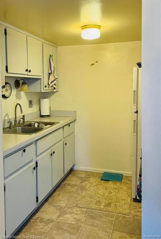 25204 Franklin Ter # 6, South Lyon, MI 48178 - kitchen featuring white fridge with ice dispenser, light countertops, white cabinets, and a sink