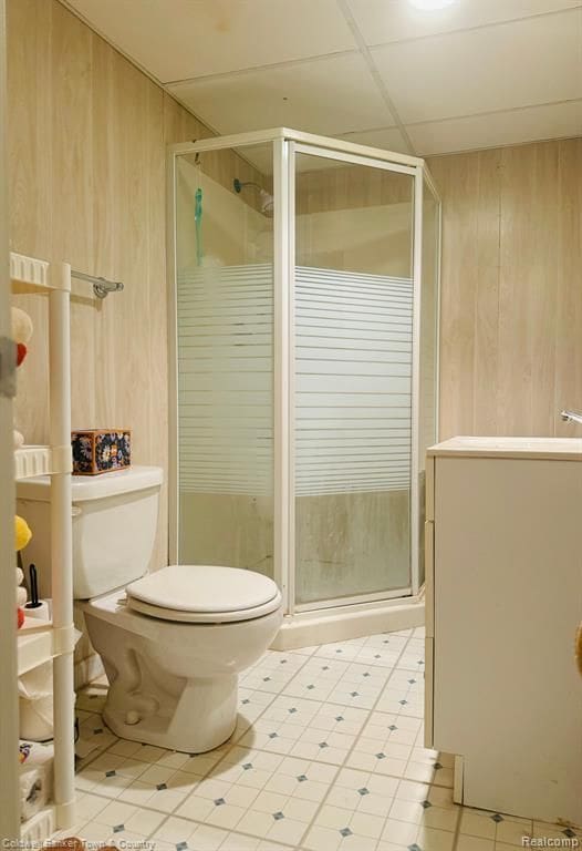 25204 Franklin Ter # 6, South Lyon, MI 48178 - full bathroom featuring tile patterned floors, toilet, wooden walls, and a stall shower