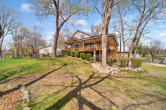 back of house with stairs, fence, a yard, and a porch