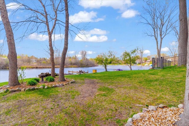 view of yard with a water view and fence
