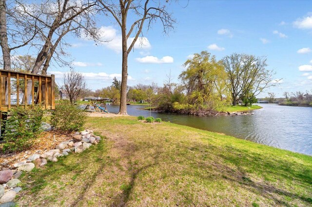 view of yard with a water view and a playground