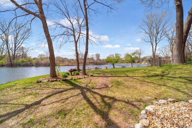 view of yard featuring a water view and fence