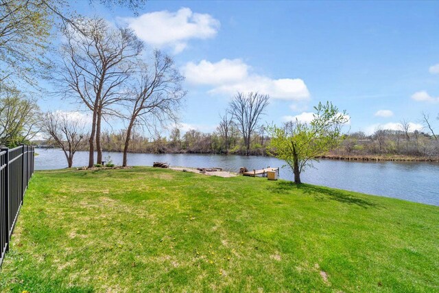 view of yard with a water view and fence