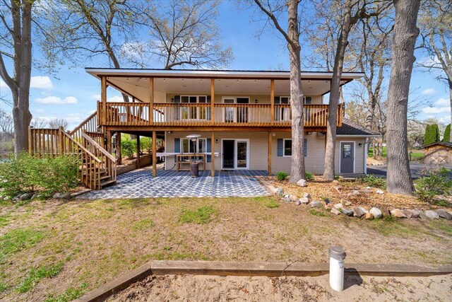 back of house featuring stairway, a patio area, and a deck