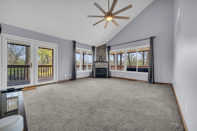 unfurnished living room featuring a fireplace, baseboards, high vaulted ceiling, a ceiling fan, and carpet