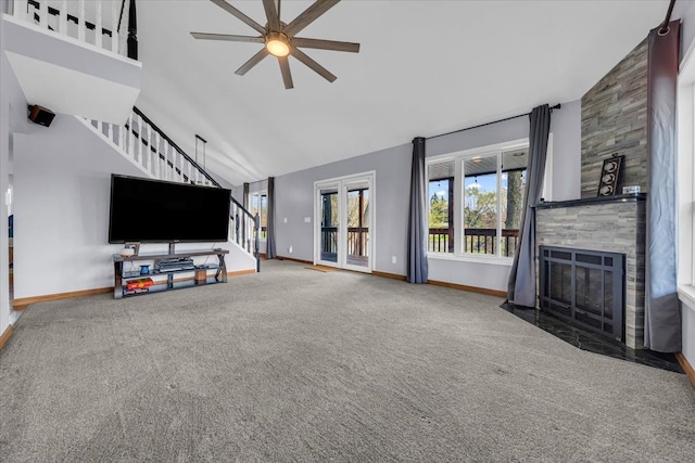 unfurnished living room with stairway, baseboards, a ceiling fan, and carpet flooring