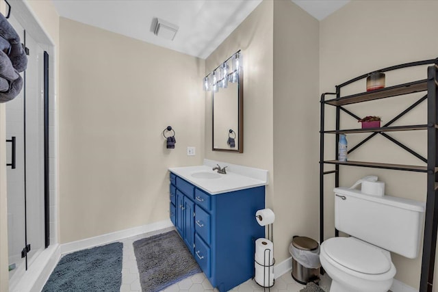 bathroom with toilet, baseboards, a shower stall, and vanity