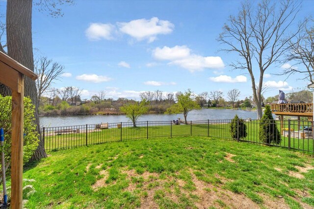 view of yard with a water view and fence