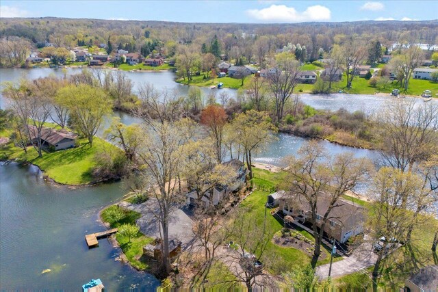 birds eye view of property with a water view and a view of trees