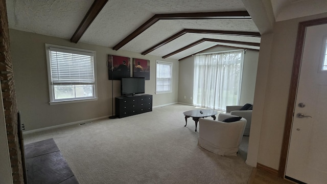 living area featuring a textured ceiling, carpet flooring, visible vents, lofted ceiling with beams, and baseboards