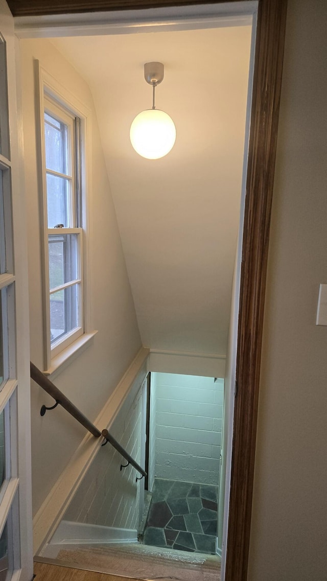 staircase featuring vaulted ceiling