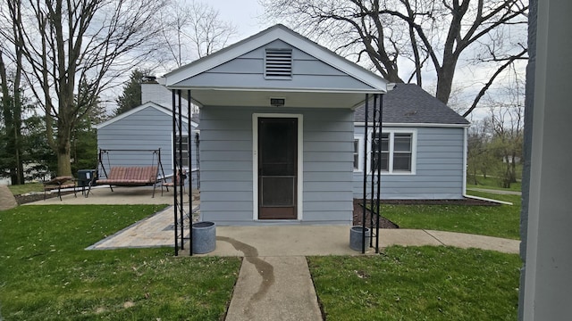 view of front of home with a patio and a front lawn