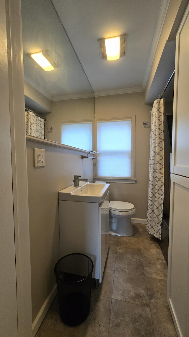 bathroom featuring ornamental molding, toilet, vanity, and plenty of natural light
