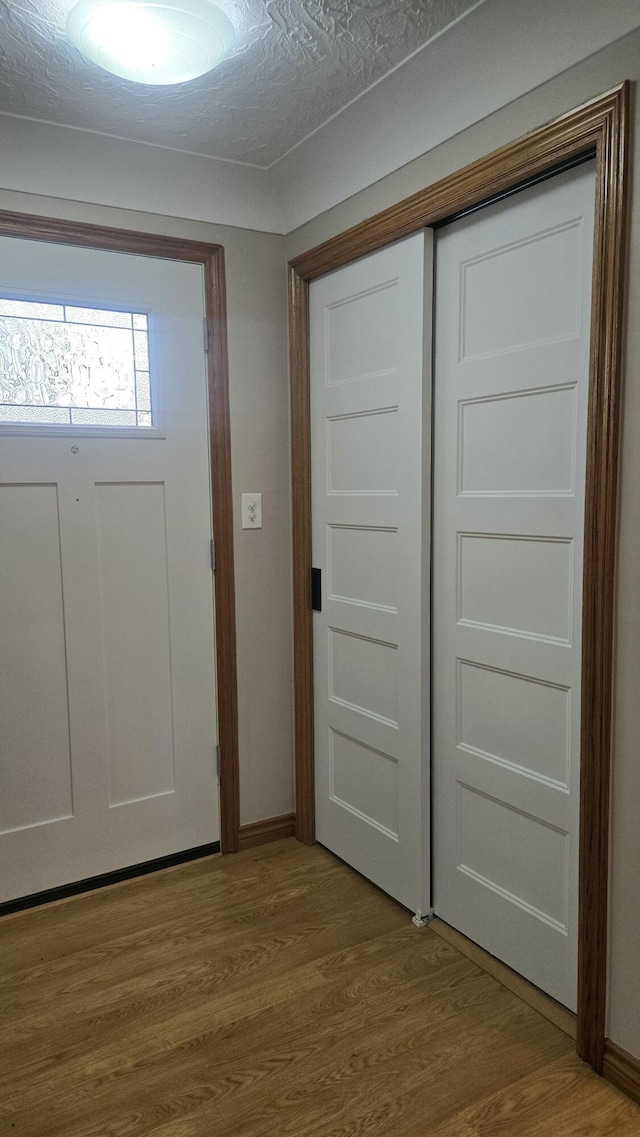 entrance foyer with wood finished floors and baseboards