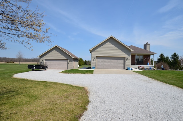 single story home featuring a chimney, a garage, a front lawn, and driveway