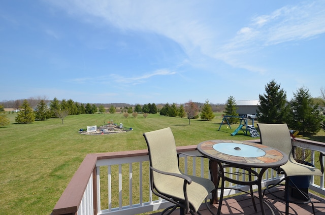 deck with a lawn and a playground