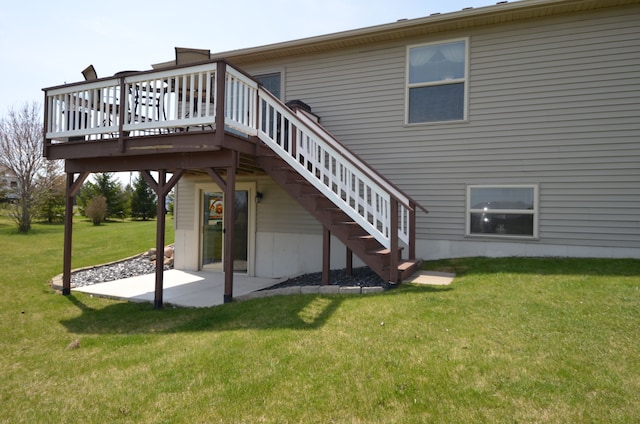 back of property featuring a patio, stairway, a wooden deck, and a lawn