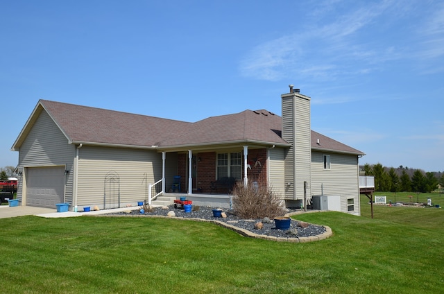rear view of property featuring concrete driveway, a chimney, a lawn, a porch, and a garage