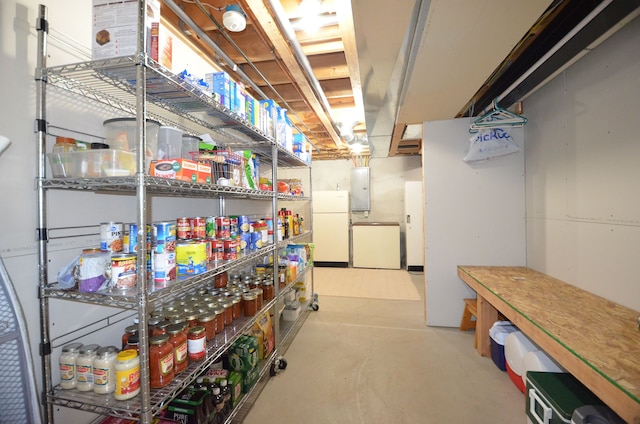 interior space with fridge, electric panel, and freestanding refrigerator
