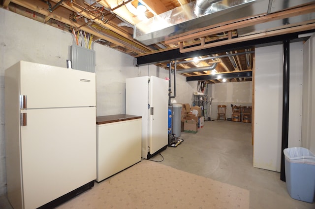 unfinished basement with refrigerator and freestanding refrigerator