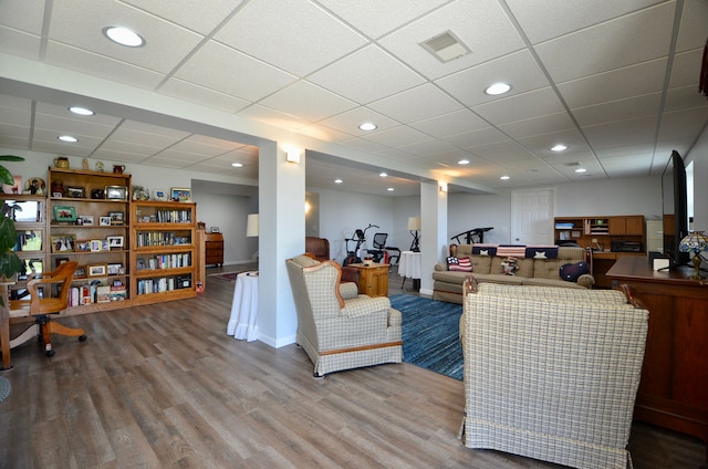 living area featuring wood finished floors, recessed lighting, visible vents, and a drop ceiling