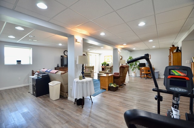 interior space with recessed lighting, a drop ceiling, wood finished floors, and baseboards
