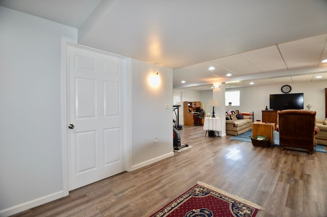 workout room featuring recessed lighting, wood finished floors, and baseboards