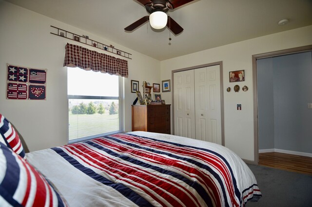 carpeted bedroom with a closet, a ceiling fan, and baseboards