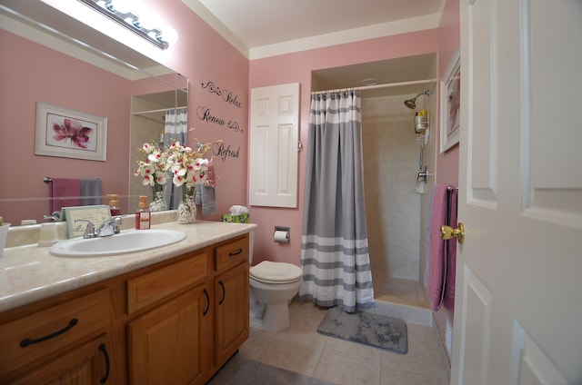 bathroom with toilet, vanity, tile patterned floors, and a tile shower