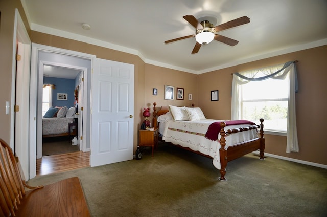 bedroom with ceiling fan, baseboards, carpet flooring, and multiple windows