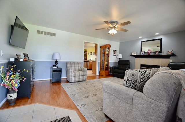 living area featuring recessed lighting, a ceiling fan, visible vents, and wood finished floors