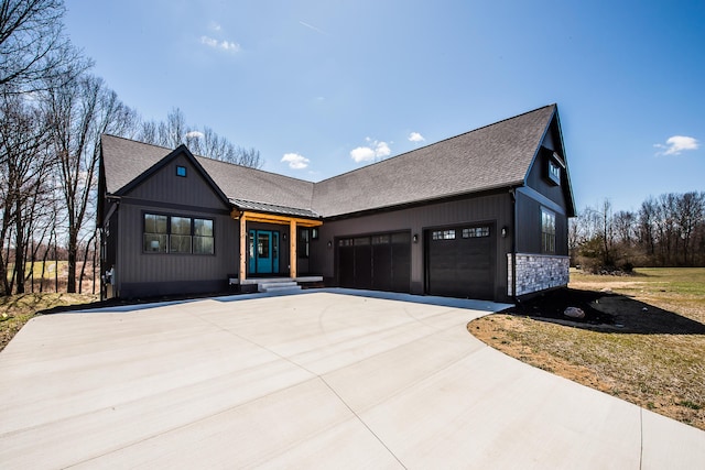 view of front of home featuring concrete driveway, a shingled roof, and an attached garage