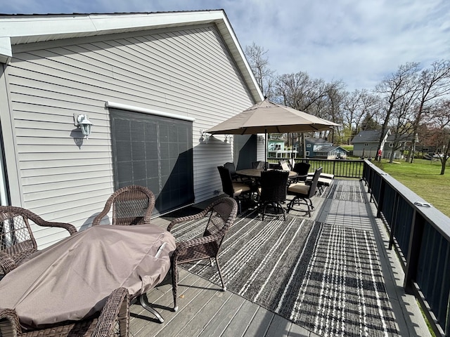 wooden deck featuring a yard and outdoor dining space