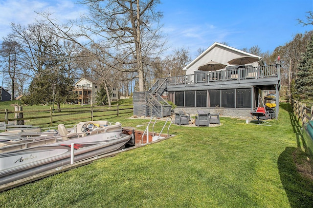 back of house with fence, a deck, a yard, and stairs