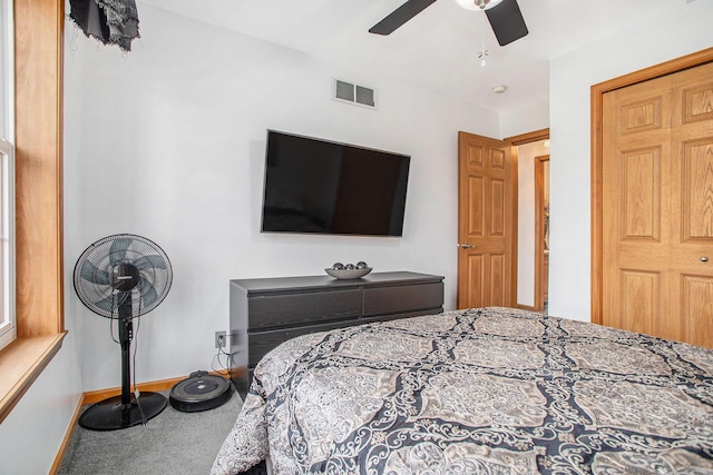 bedroom with carpet floors, visible vents, ceiling fan, and baseboards