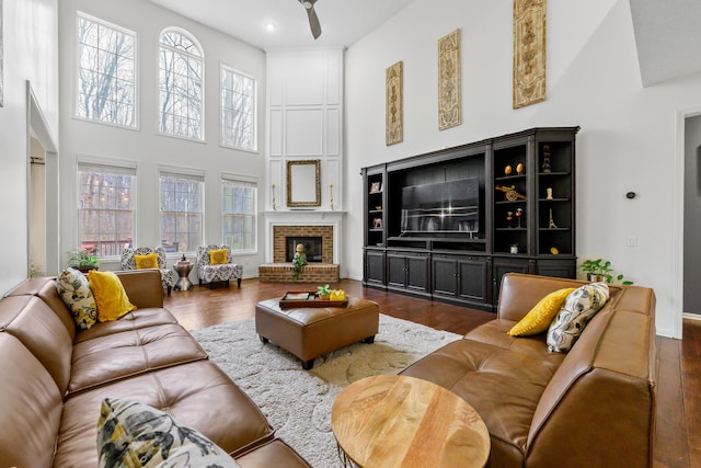 1249 Lasalle Rd, Canton, MI 48187 - living area featuring a towering ceiling, ceiling fan, wood finished floors, and a fireplace