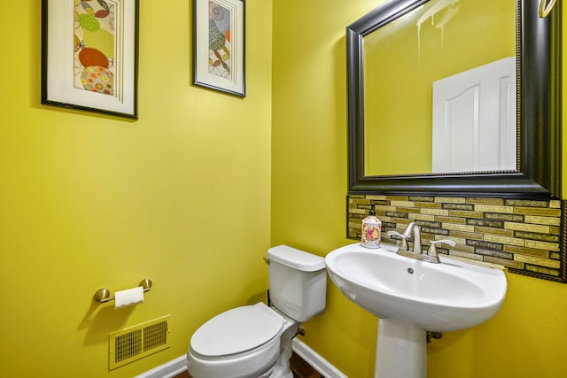 1249 Lasalle Rd, Canton, MI 48187 - half bathroom with tasteful backsplash, toilet, and baseboards