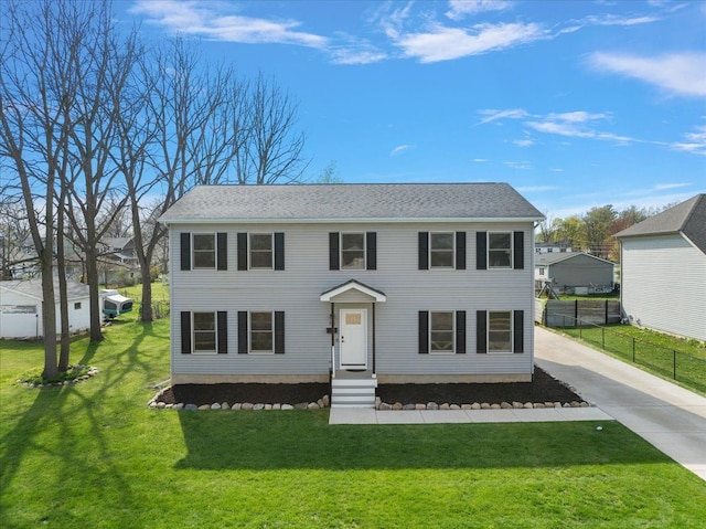 251 Dorsey St, Romeo, MI 48065 - colonial home with fence, concrete driveway, and a front lawn