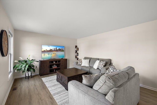 251 Dorsey St, Romeo, MI 48065 - living room featuring visible vents, wood finished floors, and baseboards