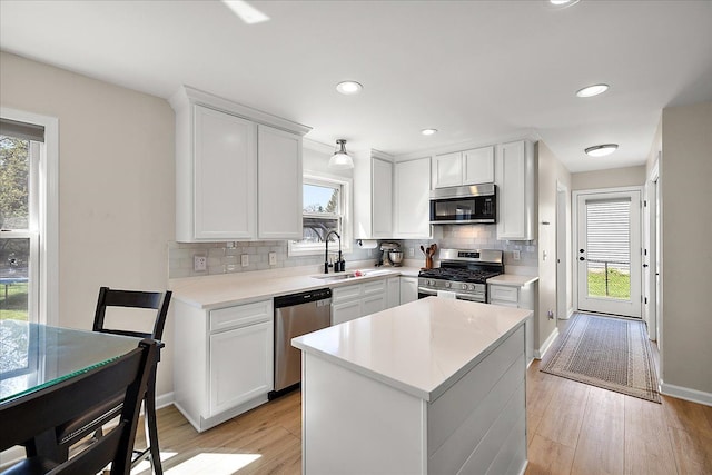 251 Dorsey St, Romeo, MI 48065 - kitchen featuring tasteful backsplash, a healthy amount of sunlight, light wood-style flooring, stainless steel appliances, and a sink