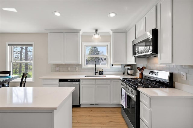 251 Dorsey St, Romeo, MI 48065 - kitchen with light wood finished floors, recessed lighting, a sink, stainless steel appliances, and backsplash