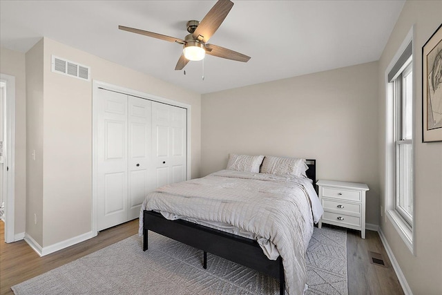 251 Dorsey St, Romeo, MI 48065 - bedroom featuring baseboards, visible vents, wood finished floors, and multiple windows