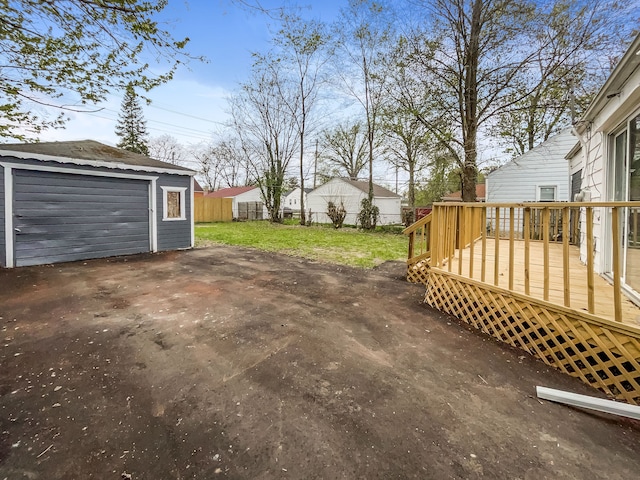 20612 Kingsville St, Harper Woods, MI 48225 - exterior space featuring fence, a wooden deck, an outdoor structure, and a garage