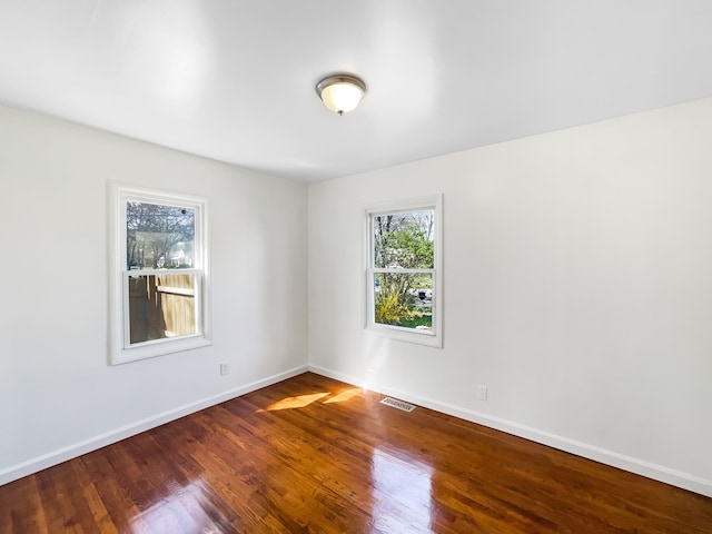 20612 Kingsville St, Harper Woods, MI 48225 - unfurnished room with baseboards, visible vents, and wood finished floors