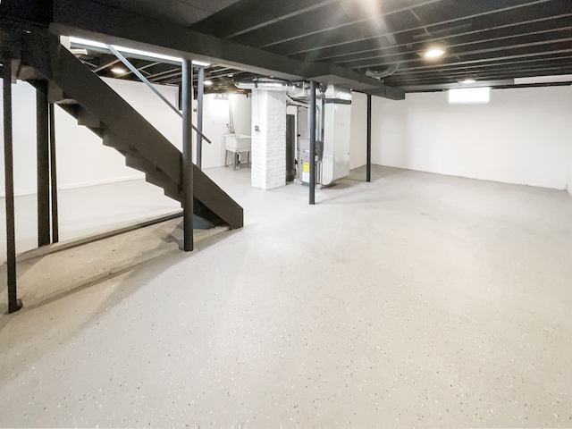 20612 Kingsville St, Harper Woods, MI 48225 - finished basement with stairs, heating unit, and a sink