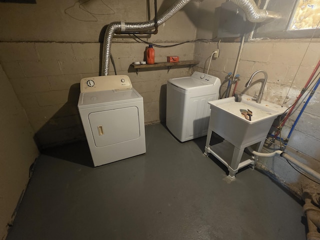 clothes washing area with a sink, laundry area, and washing machine and dryer
