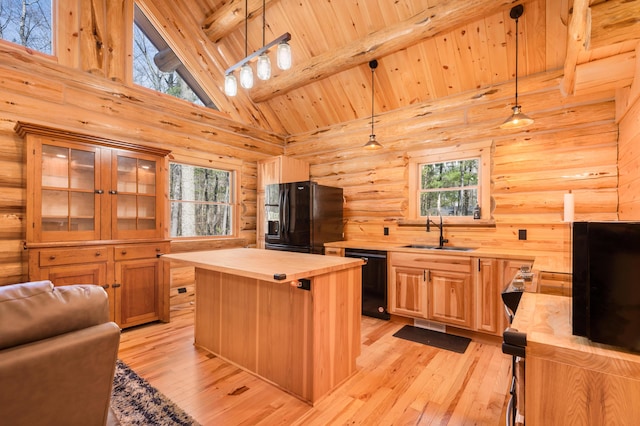 kitchen with a sink, beam ceiling, black appliances, wood ceiling, and wooden counters