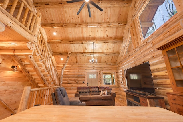 living room with wooden ceiling, beam ceiling, high vaulted ceiling, log walls, and ceiling fan with notable chandelier