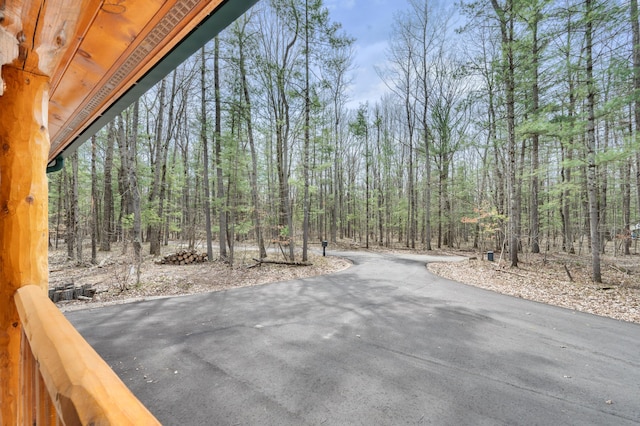 view of road featuring a wooded view