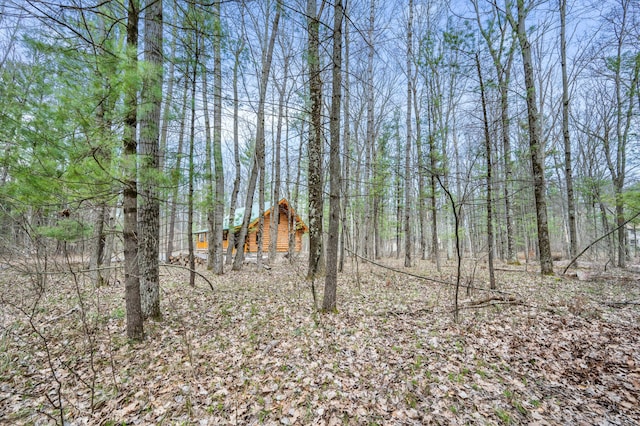 view of landscape featuring a wooded view